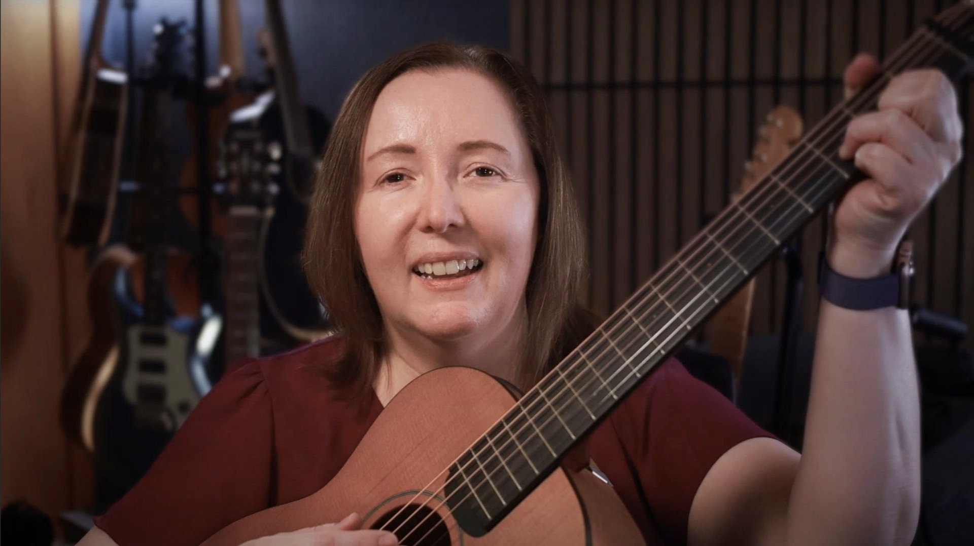 Becky Boyland in her studio playing guitar